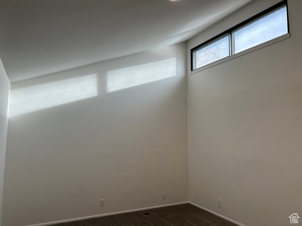 Spare room with dark carpet