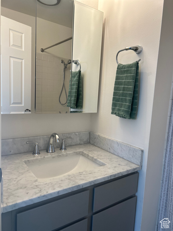Full bath with a shower with shower curtain and vanity
