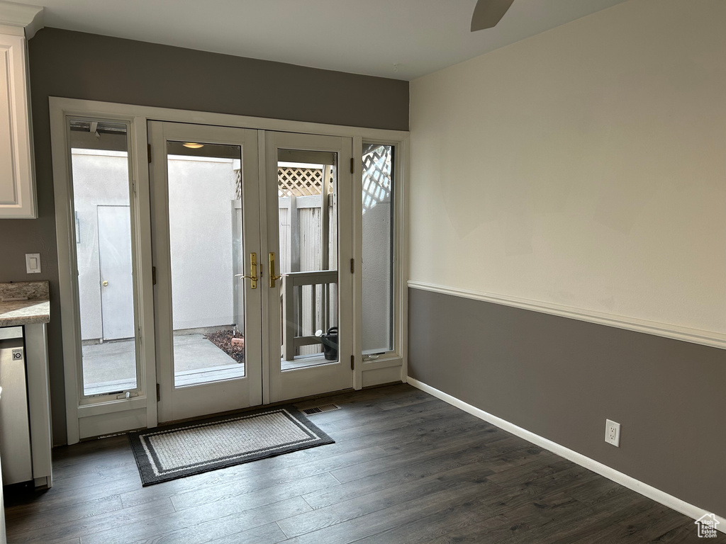 Doorway featuring french doors, dark hardwood / wood-style flooring, and a wealth of natural light