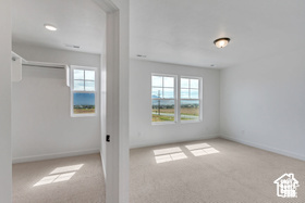 Interior space featuring plenty of natural light and light colored carpet