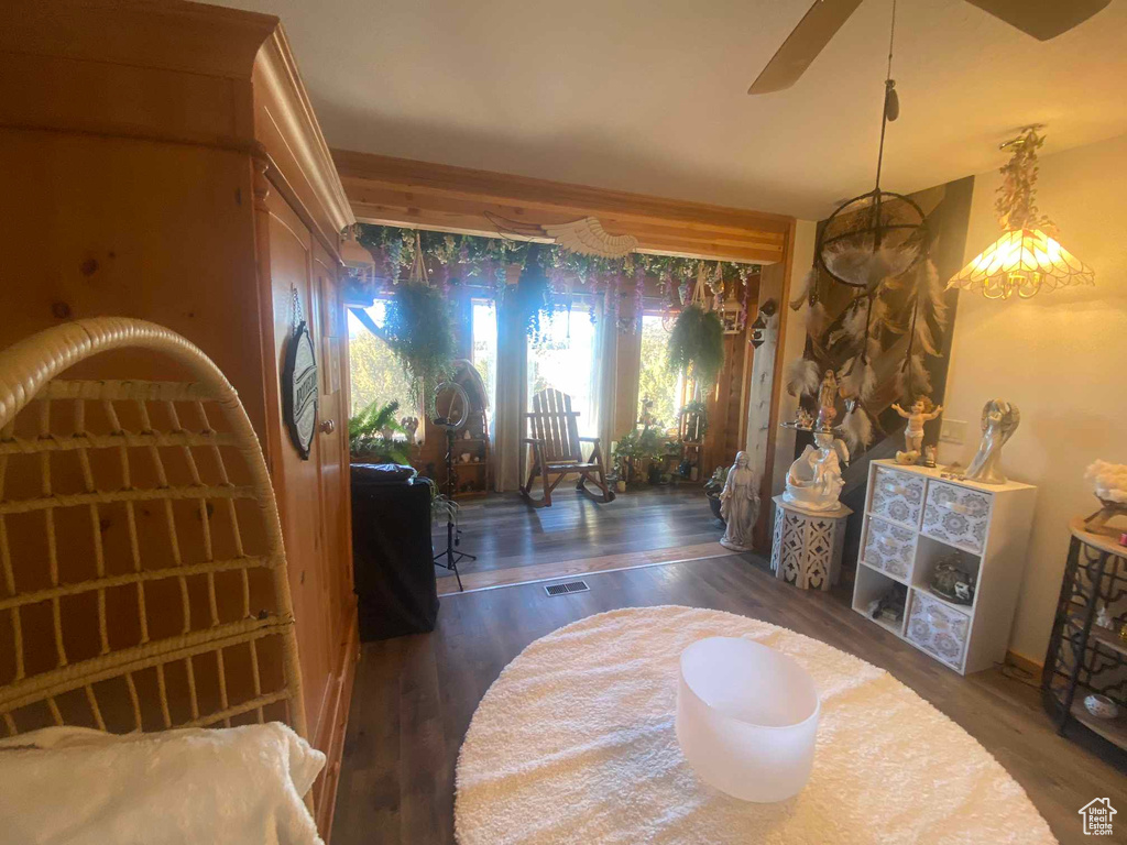 Living room featuring ceiling fan, wood finished floors, and visible vents