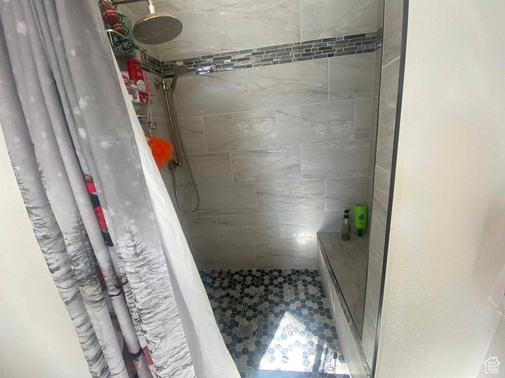 Full bathroom featuring a shower stall