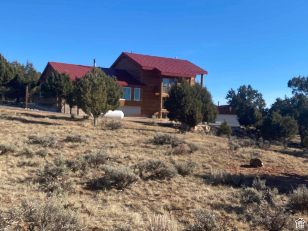 View of front of house with metal roof