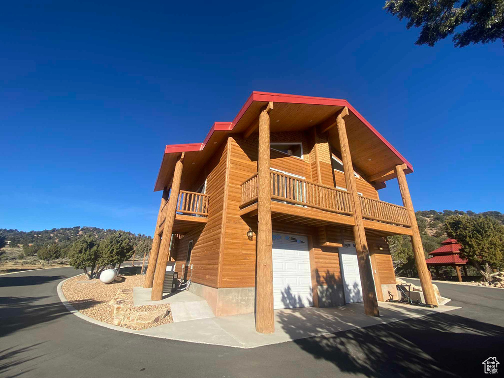 View of front of house with a balcony and an attached garage