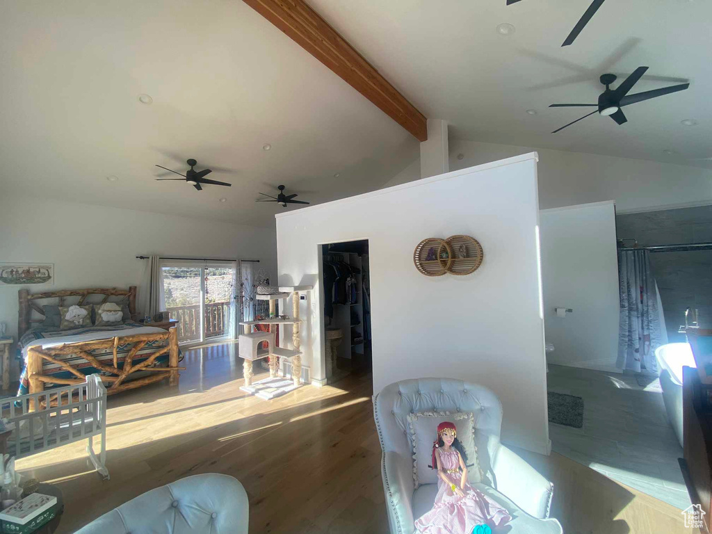 Living room with vaulted ceiling with beams and wood finished floors