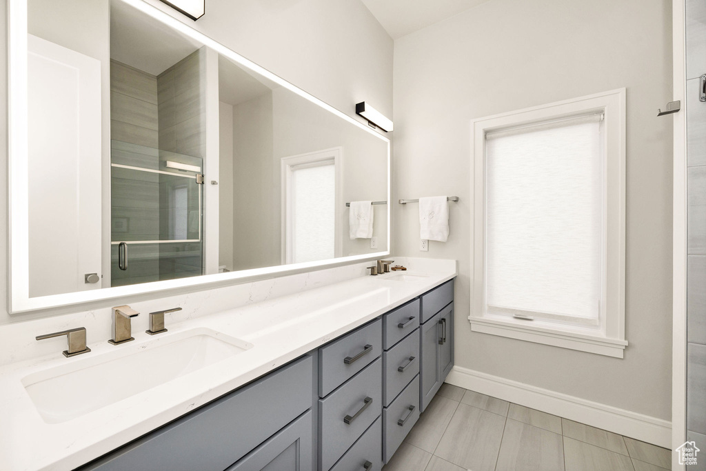 Bathroom featuring vanity and a shower with shower door