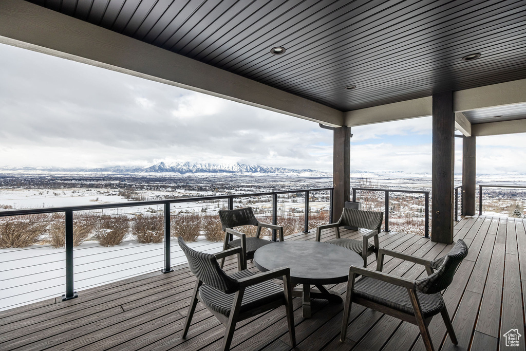 Snow covered deck with a mountain view