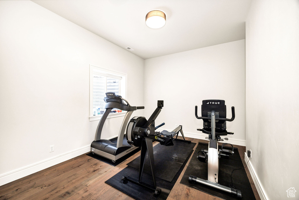 Exercise area featuring wood-type flooring