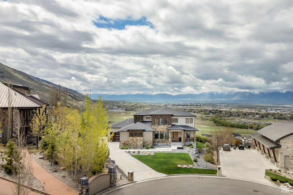 Exterior space with a mountain view and stone siding