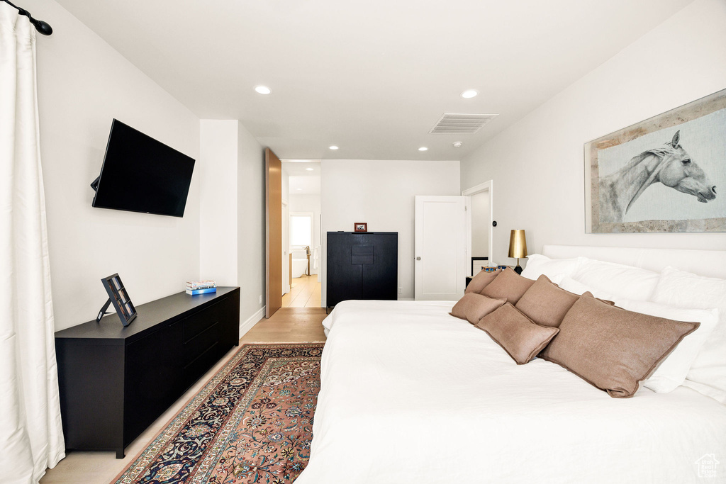 Bedroom with light hardwood / wood-style flooring