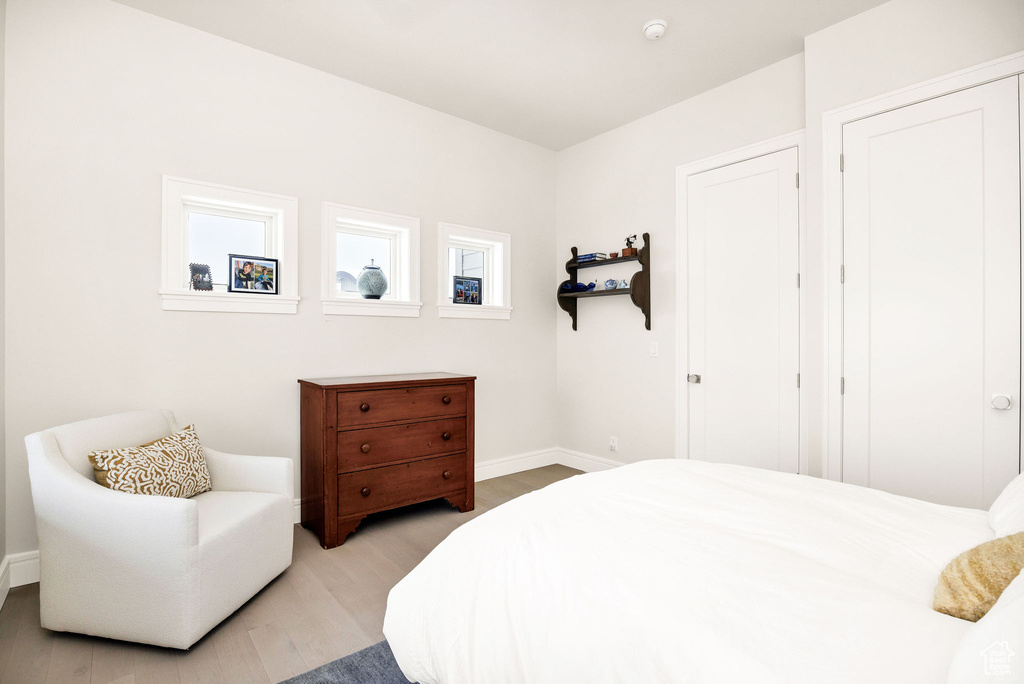Bedroom with light hardwood / wood-style floors