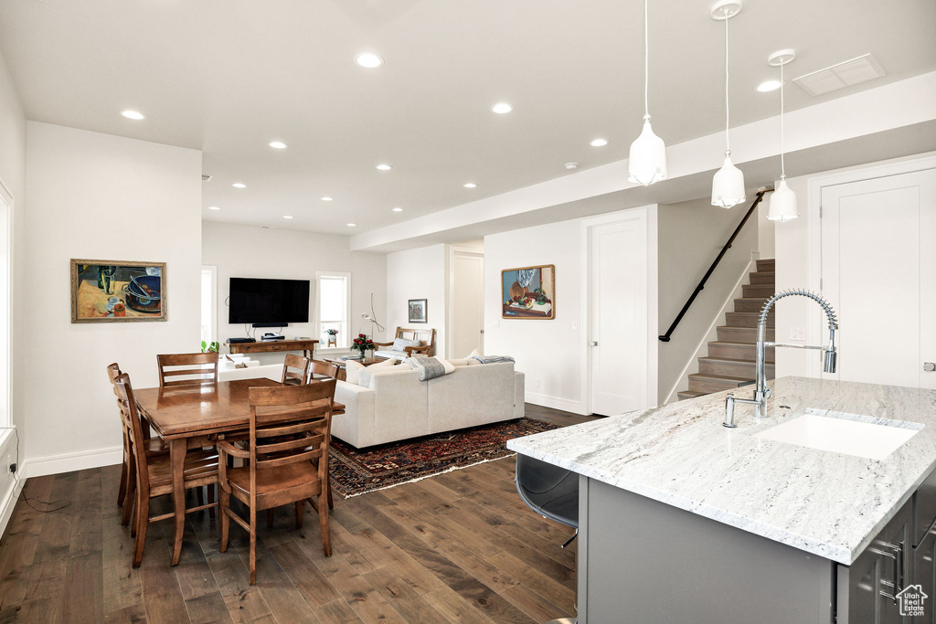 Dining room with dark hardwood / wood-style flooring and sink