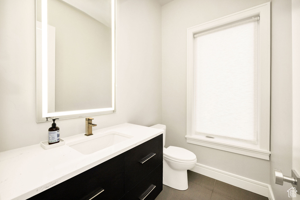 Bathroom with vanity, tile patterned flooring, and toilet
