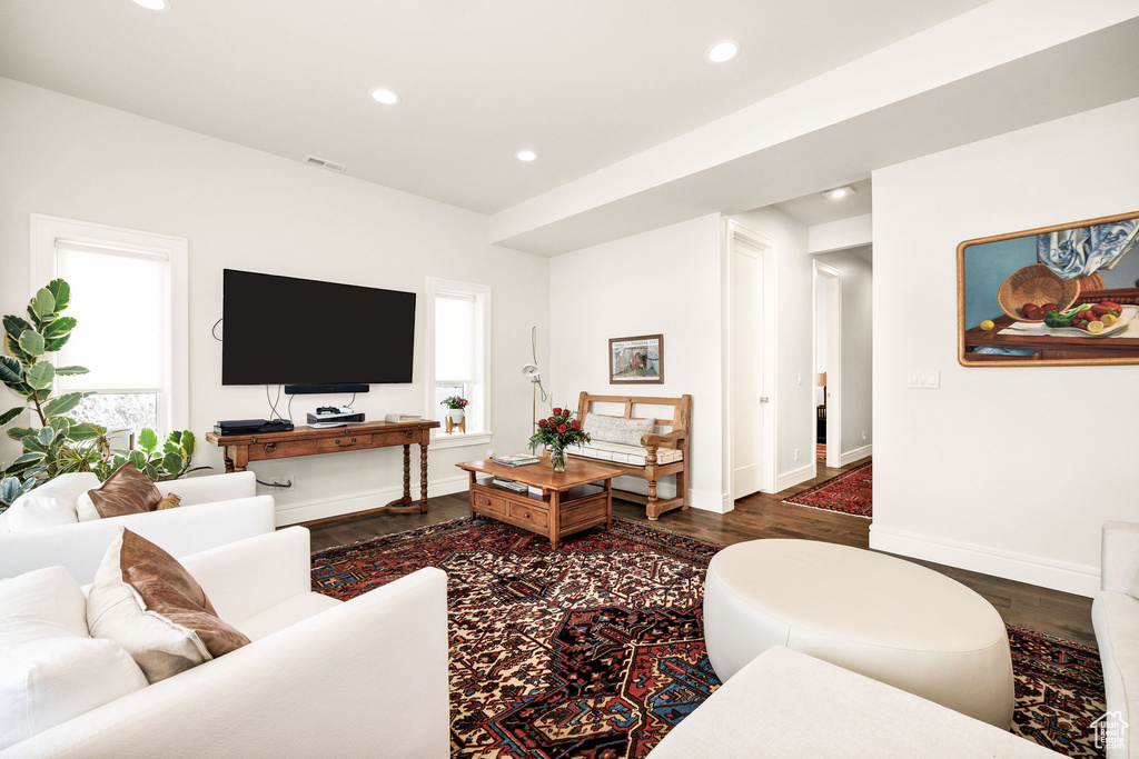 Living room with plenty of natural light and dark hardwood / wood-style floors