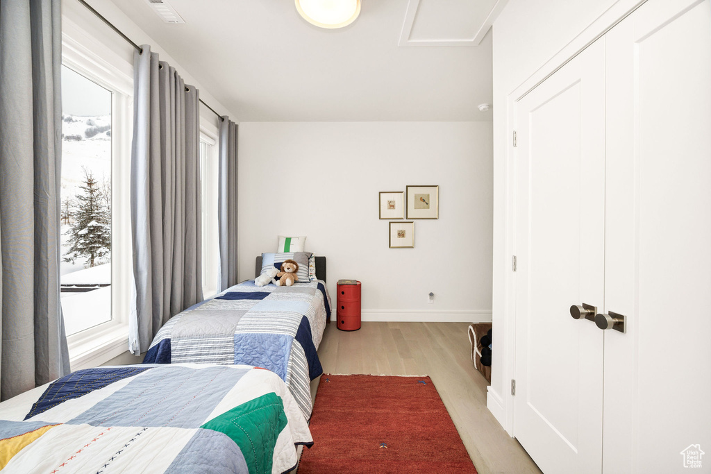 Bedroom with hardwood / wood-style flooring