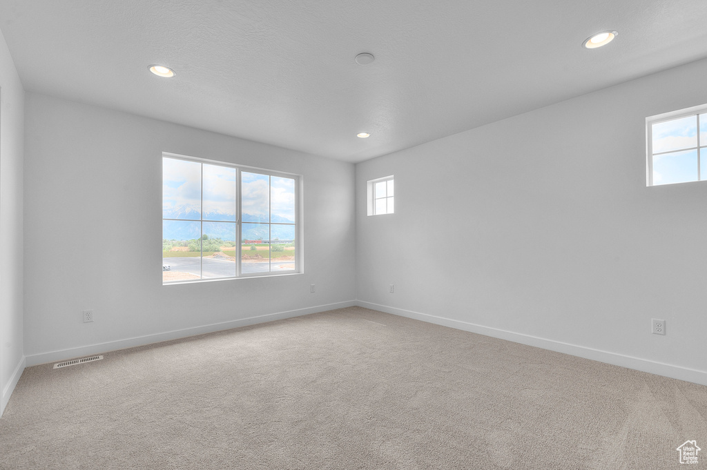 Spare room featuring recessed lighting, baseboards, and carpet floors