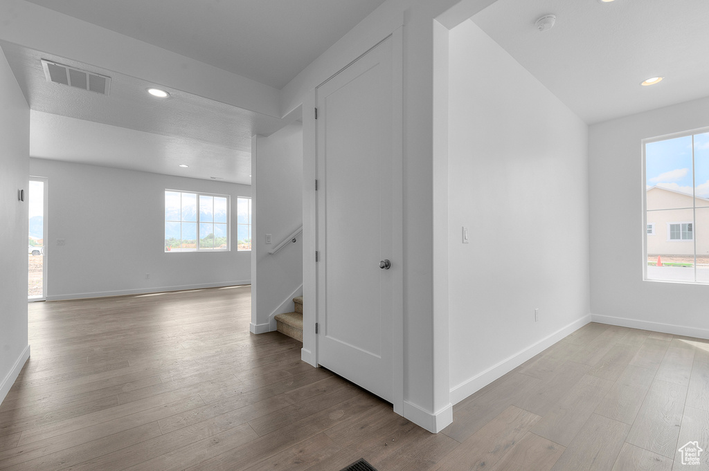 Spare room featuring stairway, recessed lighting, wood finished floors, baseboards, and a smoke detector
