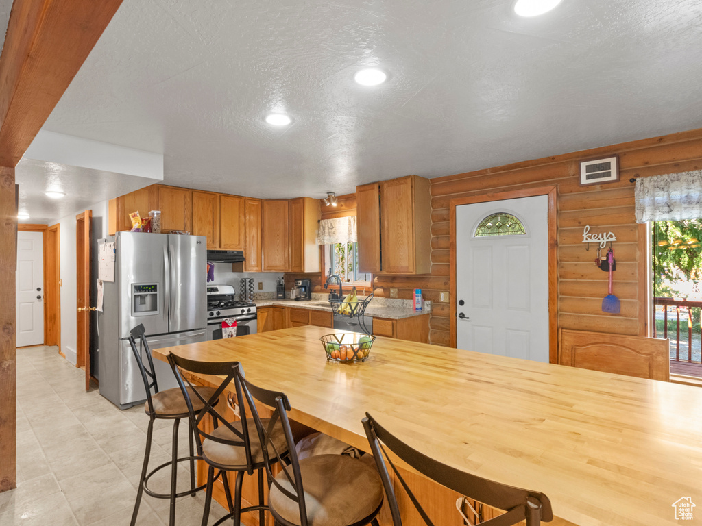 Kitchen with a textured ceiling and stainless steel appliances