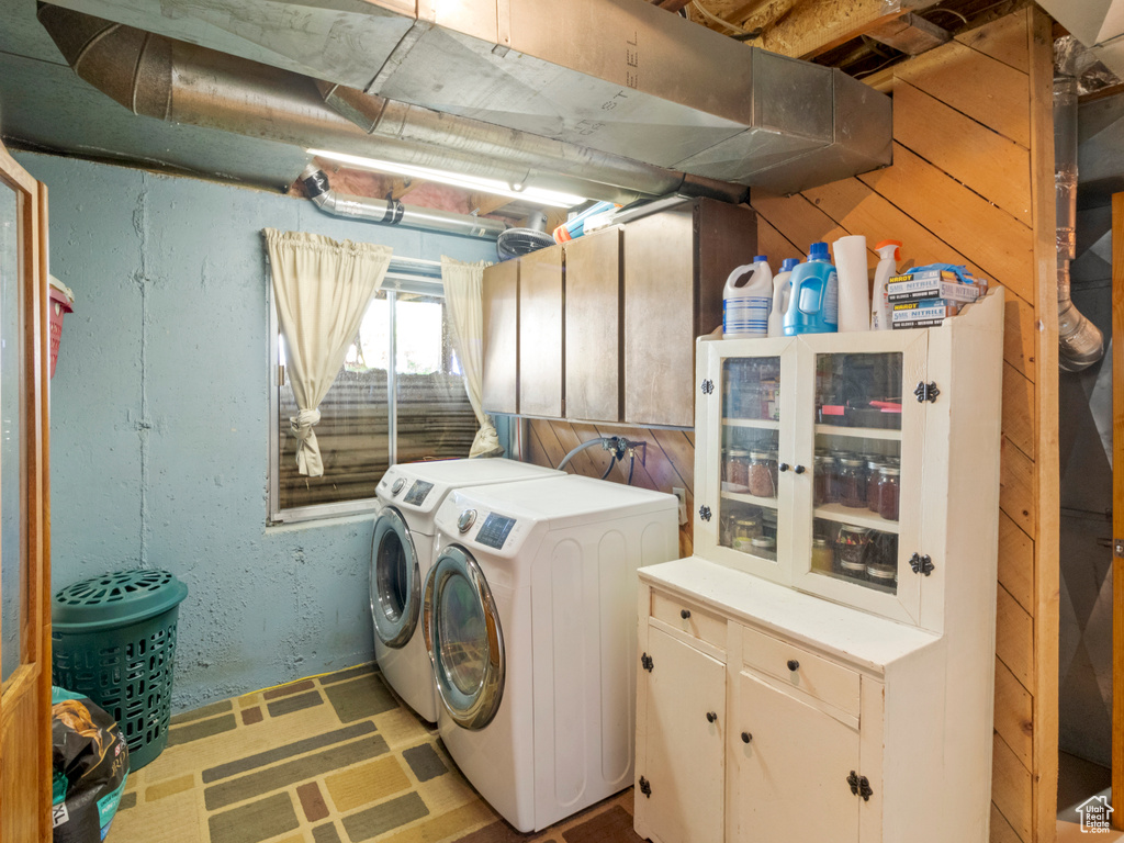 Washroom featuring cabinets and separate washer and dryer