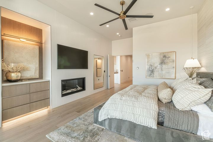 Bedroom featuring ceiling fan and light hardwood / wood-style flooring