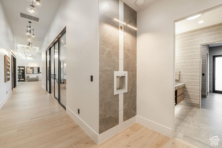 Hallway with light hardwood / wood-style floors