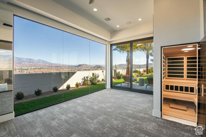 Unfurnished sunroom featuring a water and mountain view