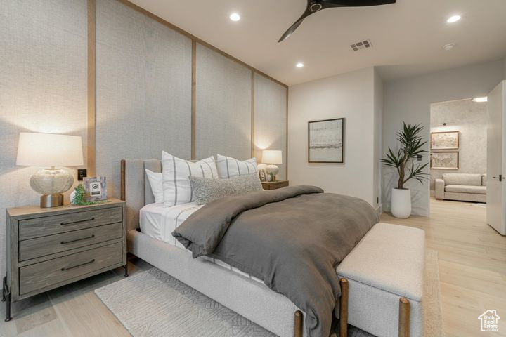 Bedroom with ceiling fan and light hardwood / wood-style flooring