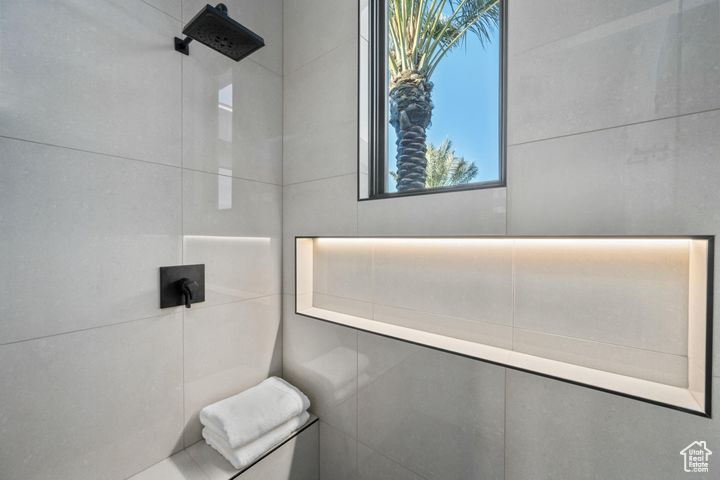 Bathroom with a shower and tile walls
