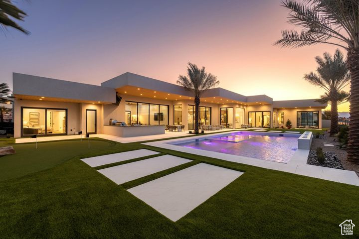 Back house at dusk with a patio