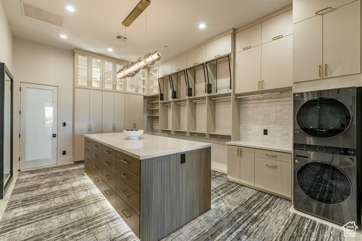 Interior space with stacked washer / dryer and cabinets
