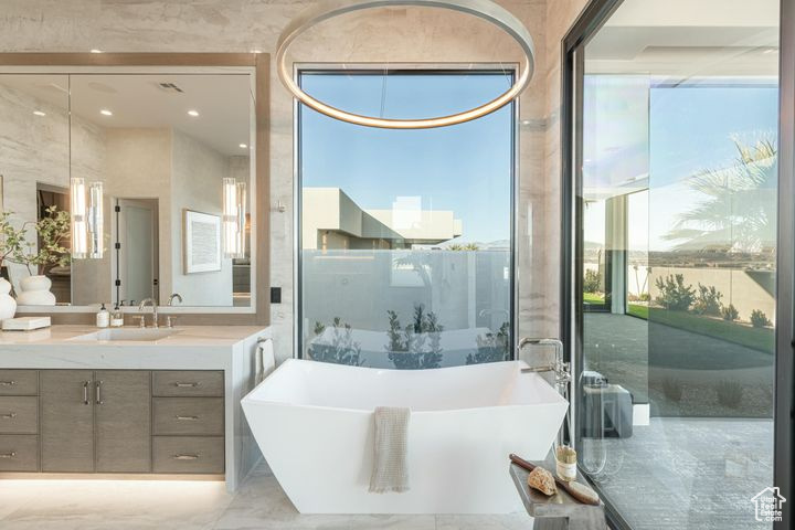 Bathroom featuring a bathing tub and vanity