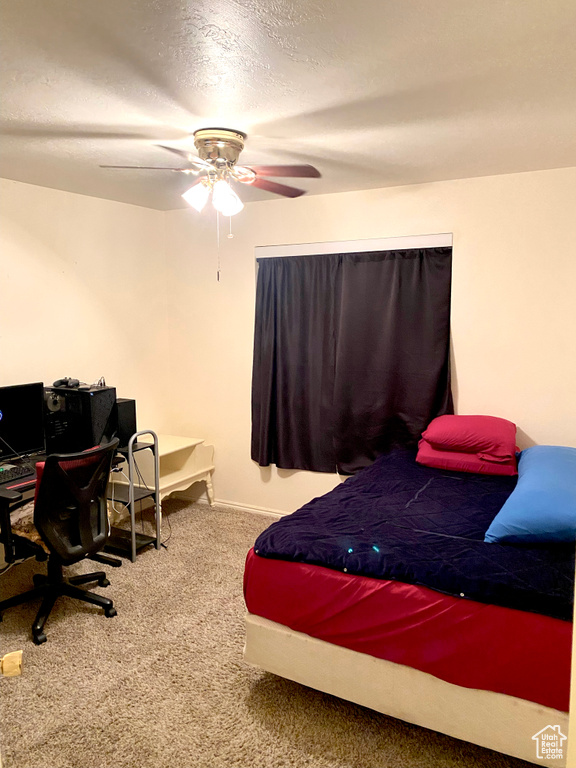 Bedroom featuring carpet floors, a textured ceiling, and a ceiling fan