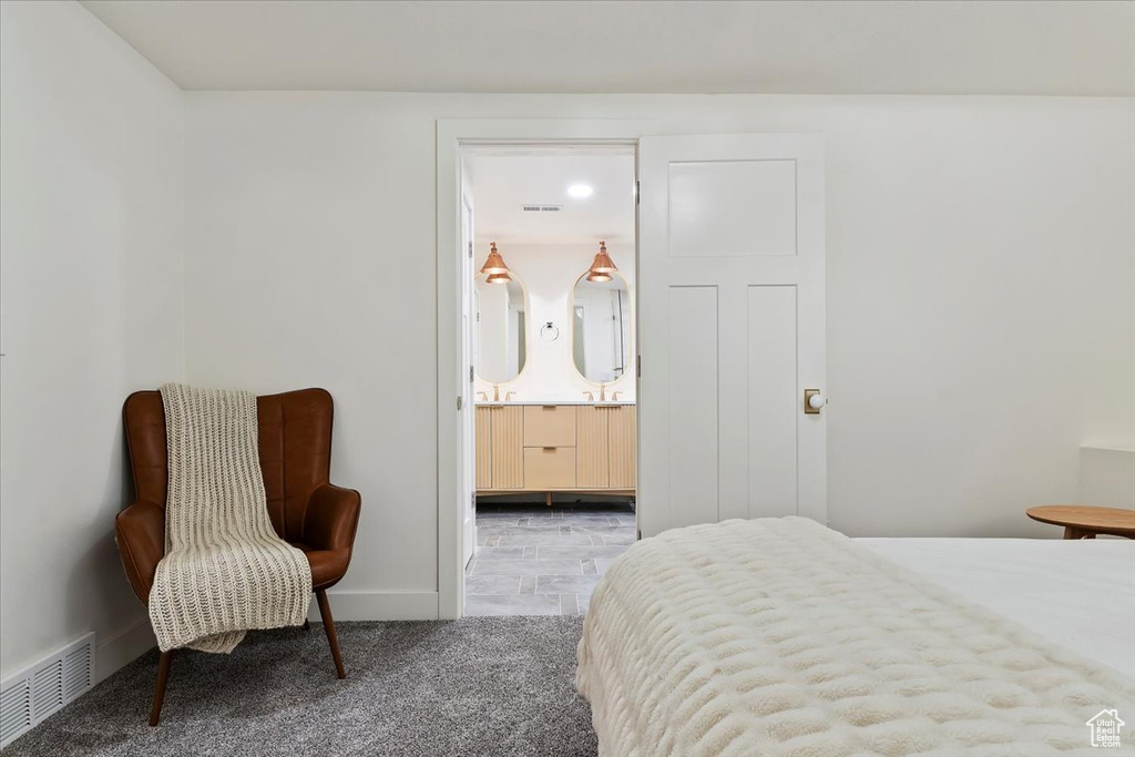 Carpeted bedroom featuring connected bathroom