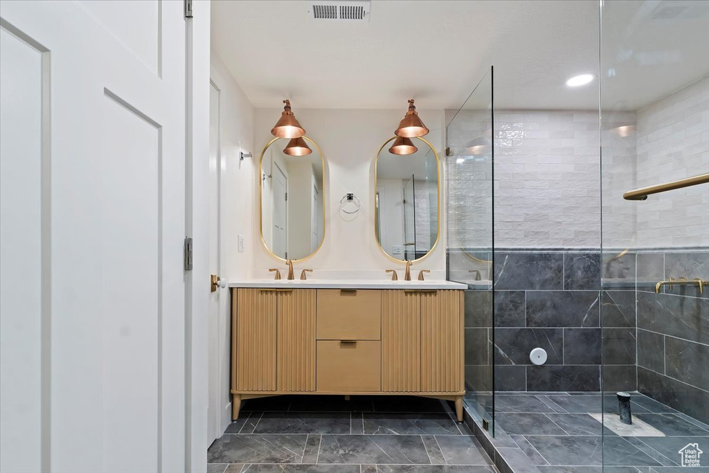 Bathroom with a tile shower and vanity