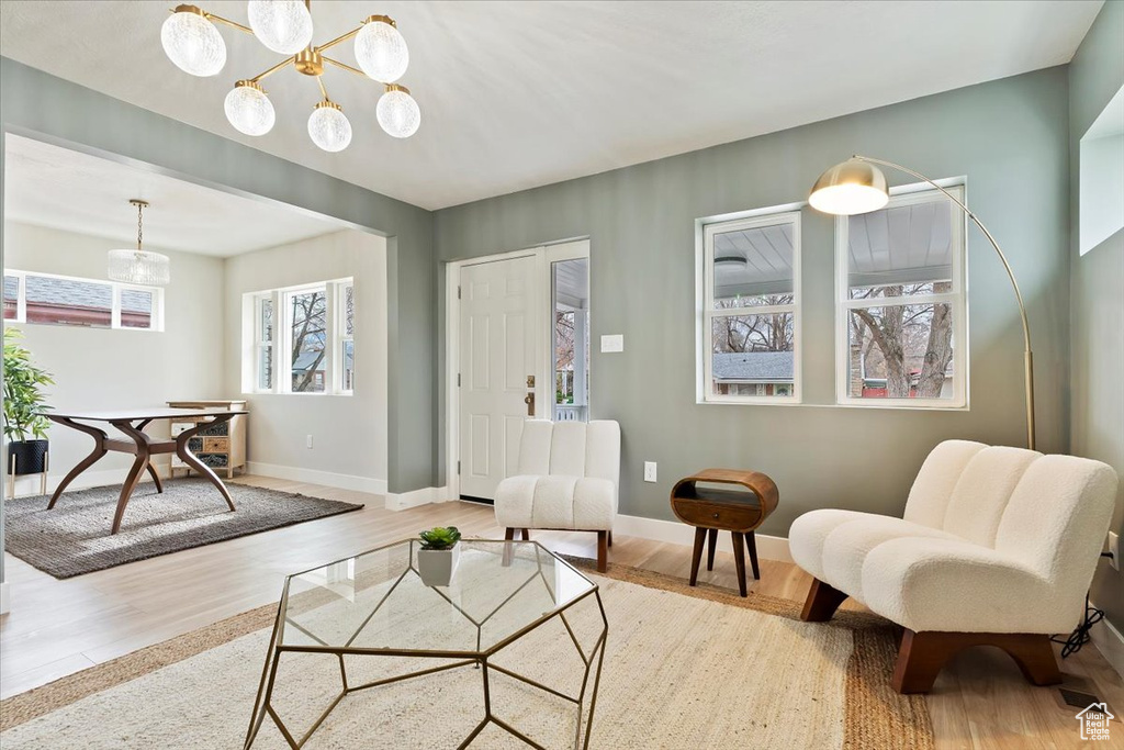 Living room with hardwood / wood-style flooring and an inviting chandelier