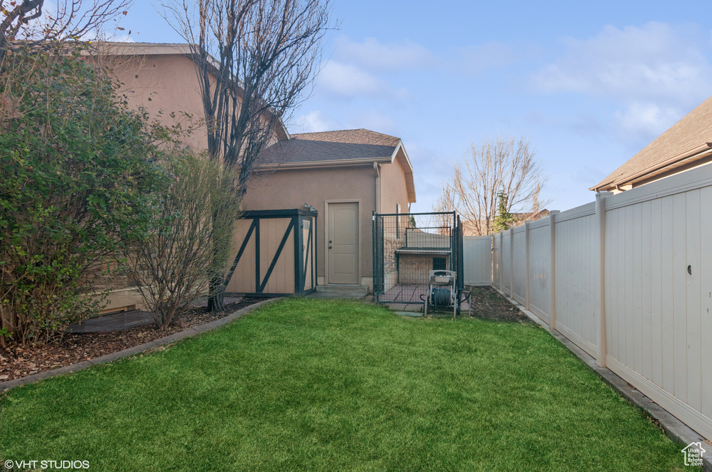 View of yard featuring a fenced backyard and a gate