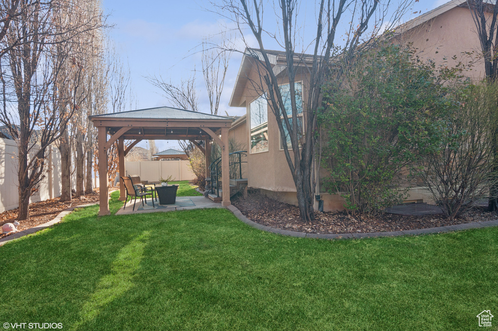 View of yard featuring a gazebo, fence, and a patio