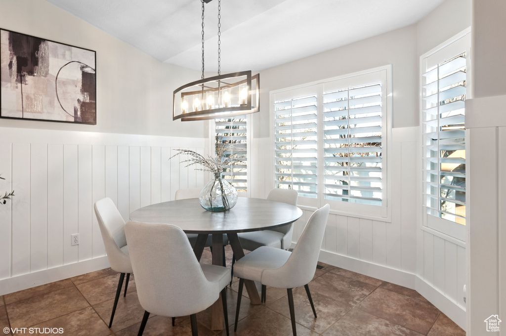 Dining space featuring a wainscoted wall