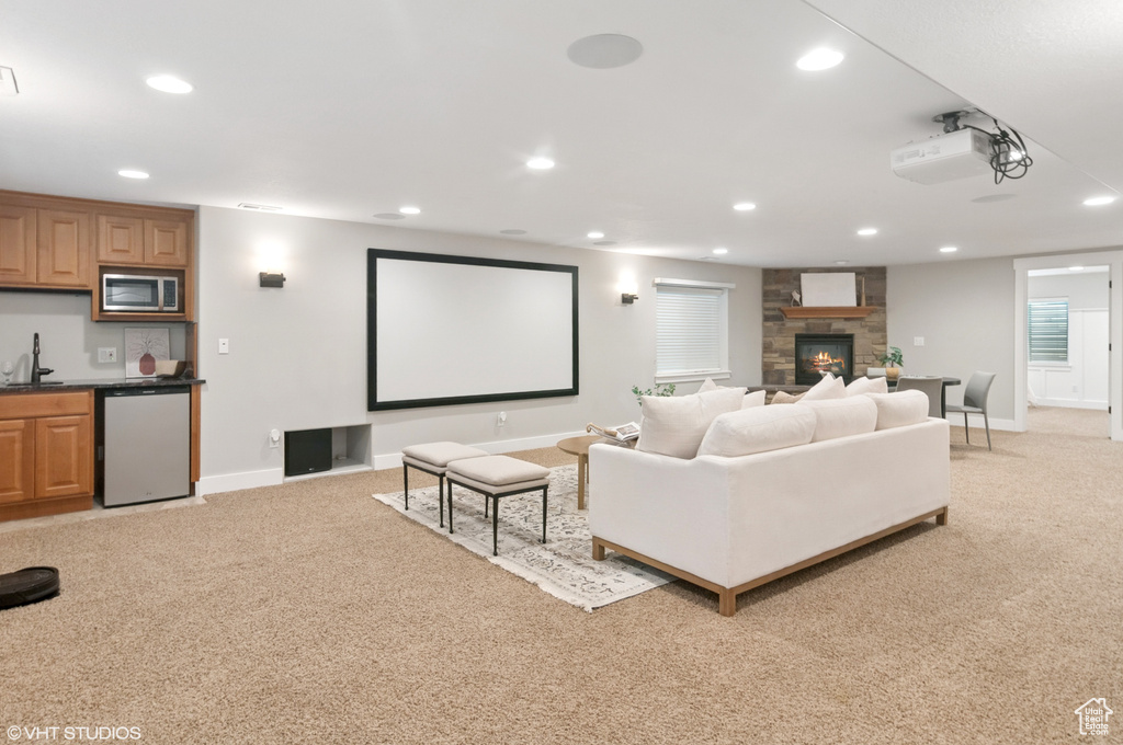 Home theater room with recessed lighting and light colored carpet