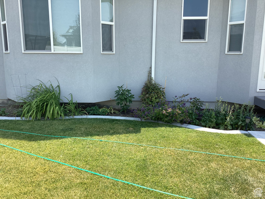 View of property exterior with a yard