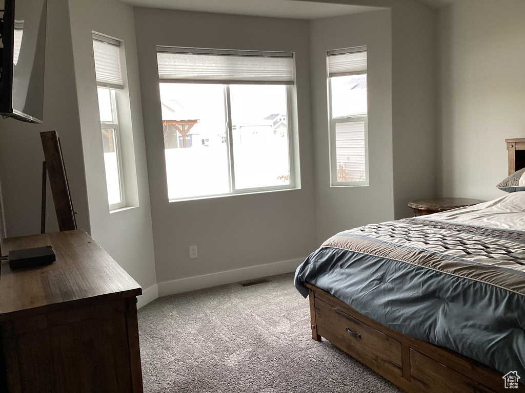 Bedroom with light colored carpet