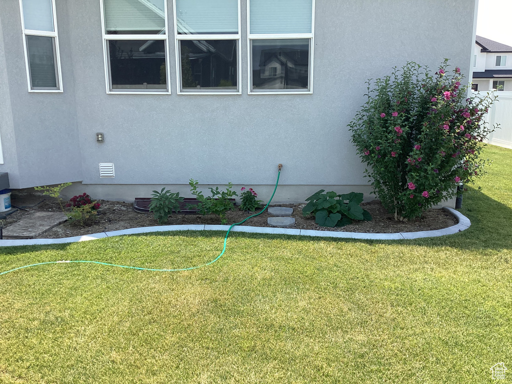 View of property exterior featuring a lawn