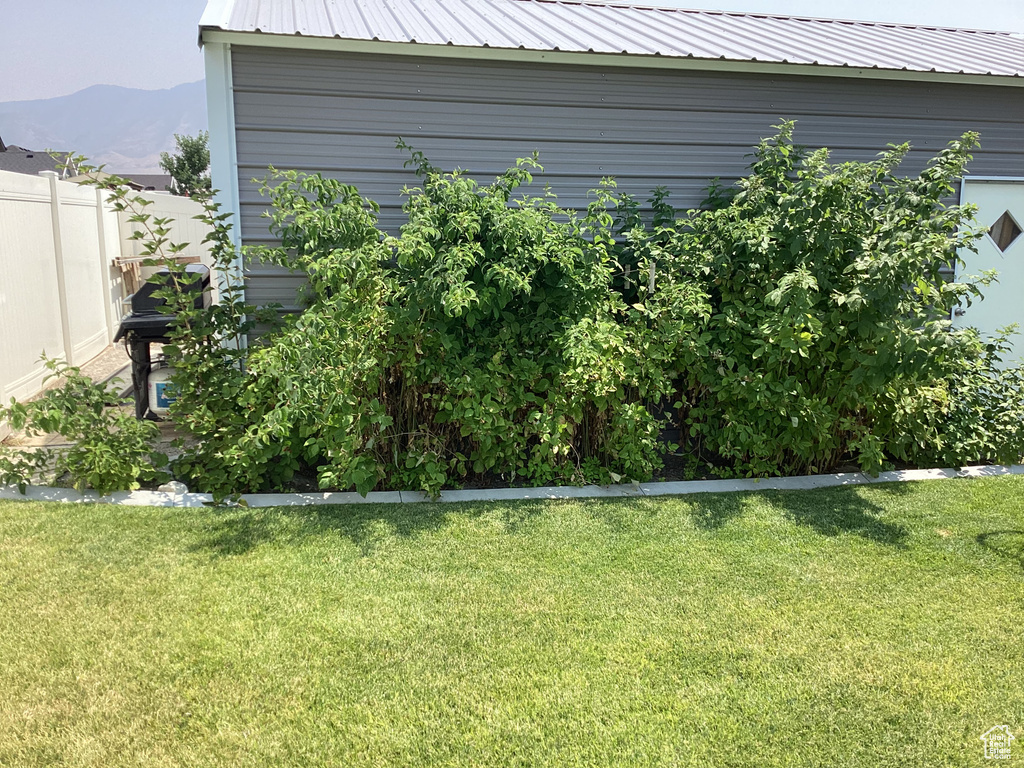 Exterior space featuring a mountain view and a lawn