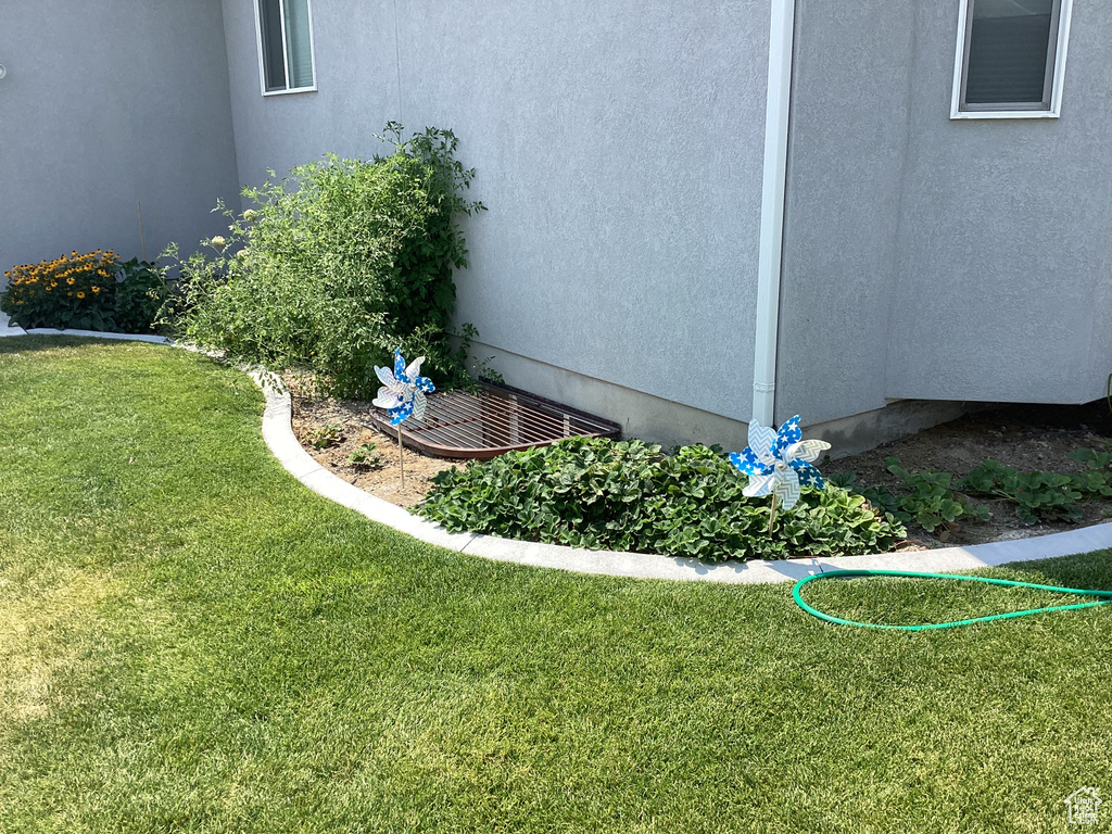 View of property exterior with a yard