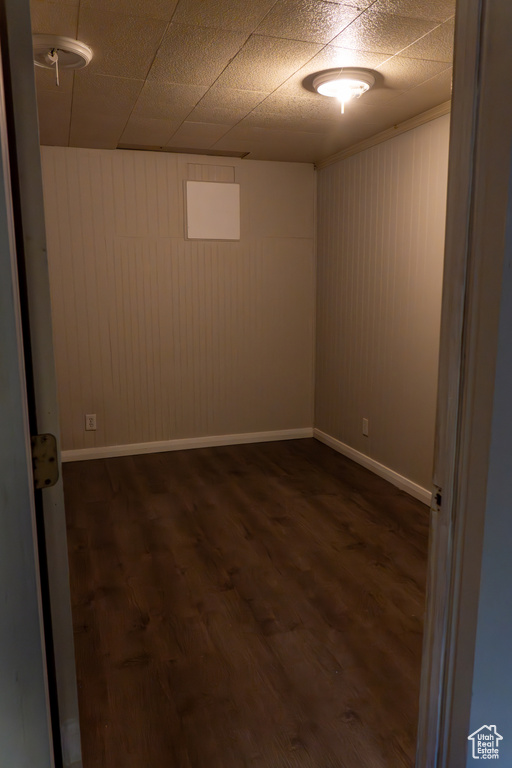 Empty room featuring dark hardwood / wood-style flooring