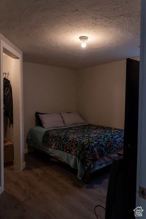 Bedroom featuring wood-type flooring and a textured ceiling