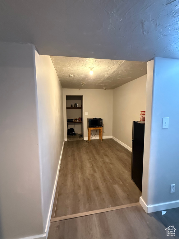 Unfurnished living room with a textured ceiling and hardwood / wood-style flooring