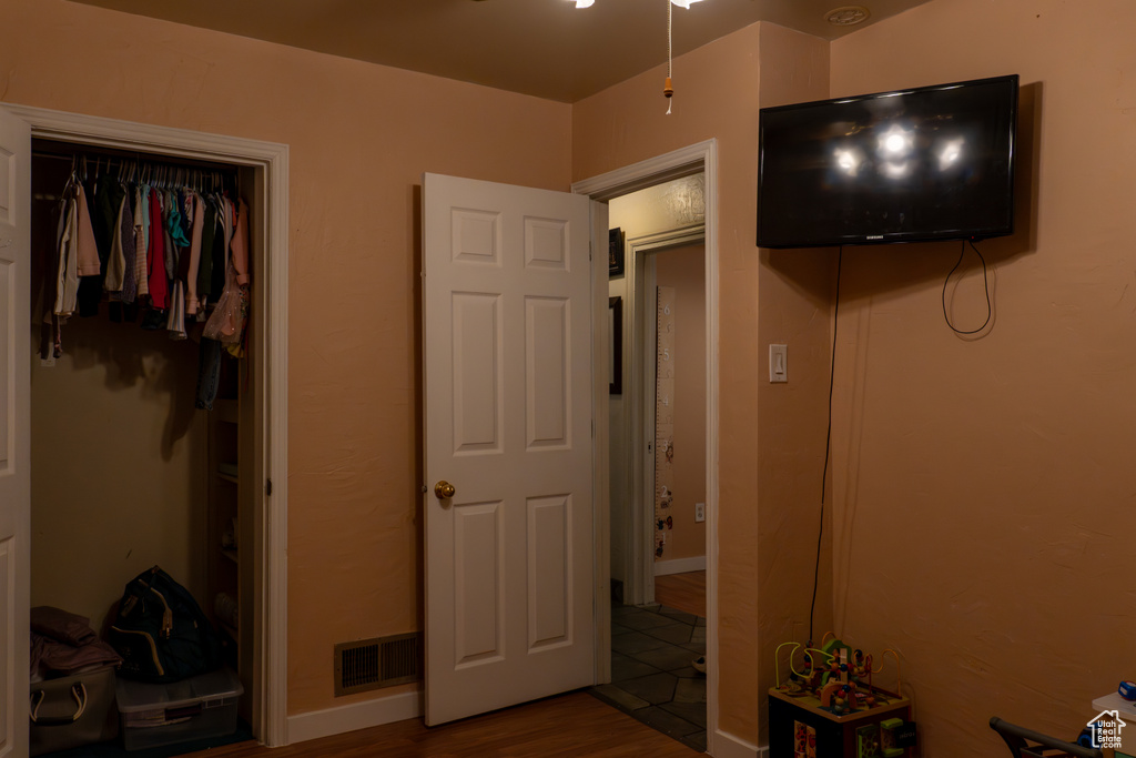 Bedroom with a closet and wood-type flooring