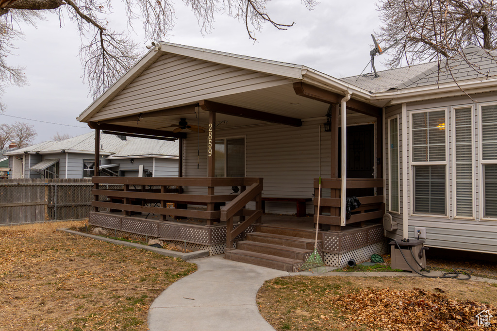 Property entrance with a wooden deck and ceiling fan