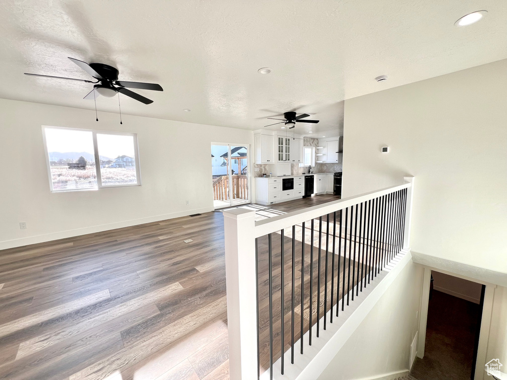 Interior space featuring hardwood / wood-style flooring, ceiling fan, and a textured ceiling